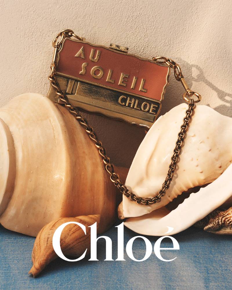 Bolsa com corrente metálica posicionada sobre conchas na campanha Chloé à la Plage 2026