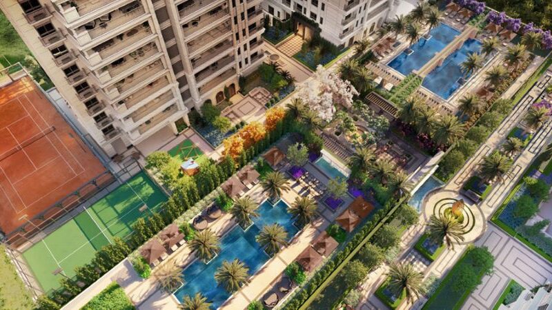 Vista aérea evidencia piscinas, áreas verdes e paisagismo integrado ao condomínio residencial