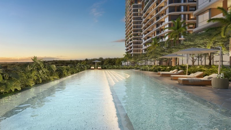 Área de piscina do Lagom Perequê com espreguiçadeiras e torres ao fundo