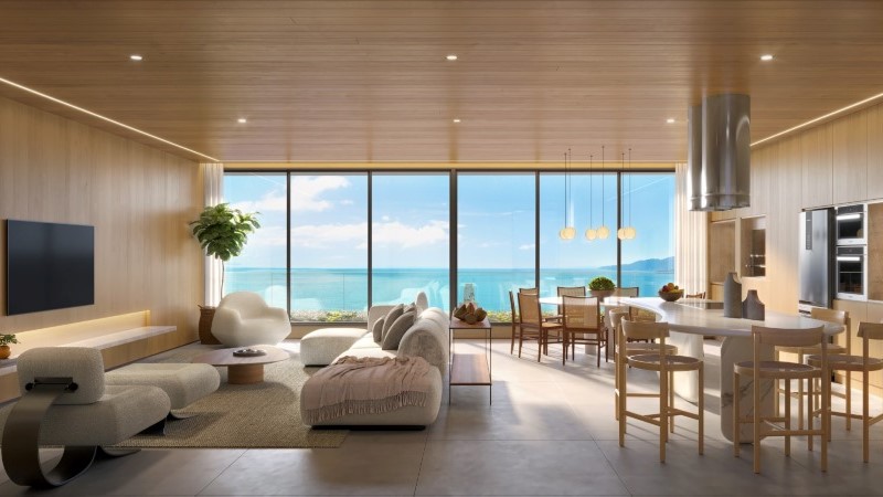 Sala de estar do Lagom Perequê com madeira, mármore e janela de vidro, o perfil do mercado imobiliário de alto padrão