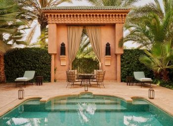 Piscina do Amanjena cercada por jardins em Marrakech